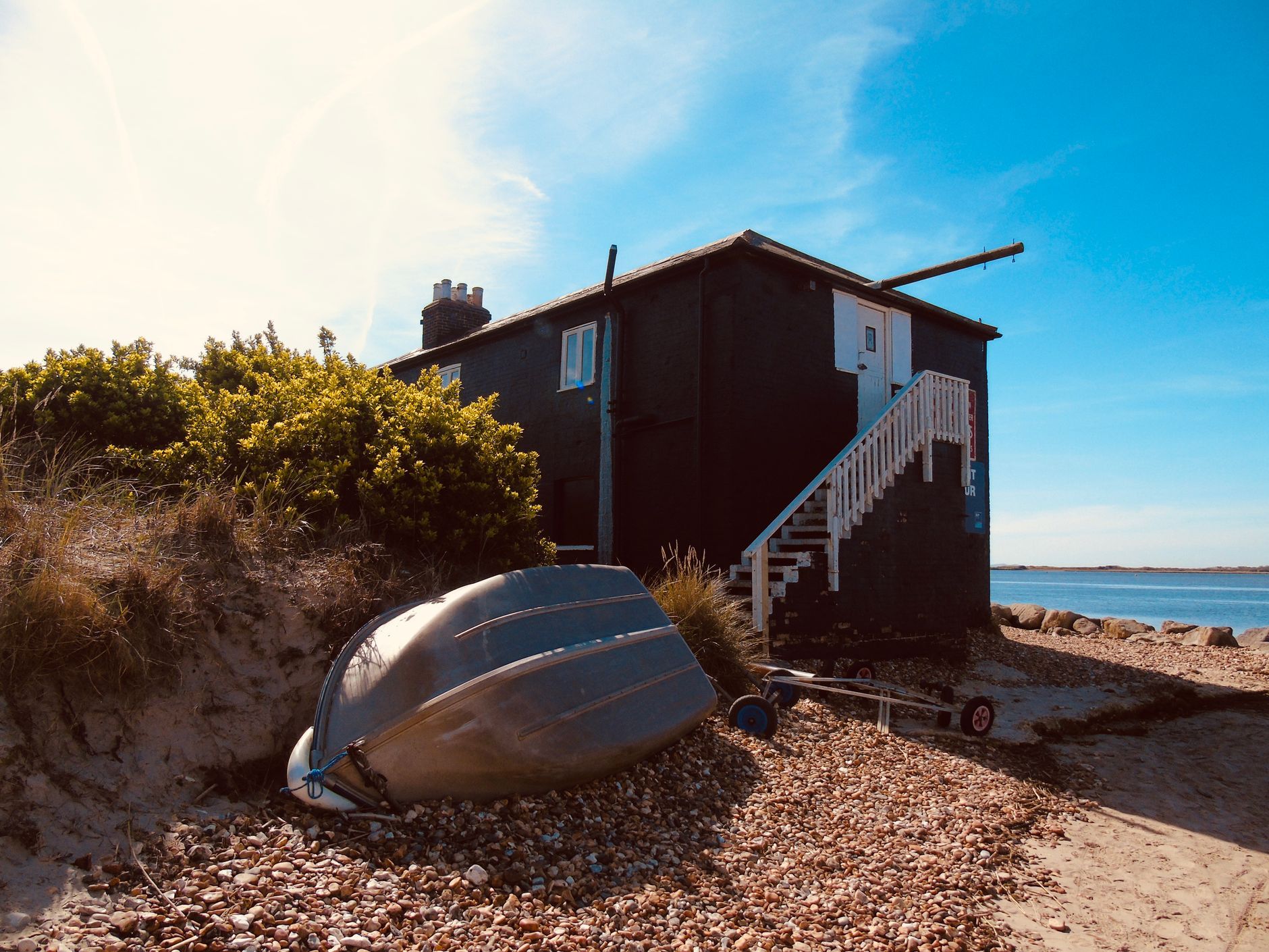 Seaside cottage with a rowboat on the shore