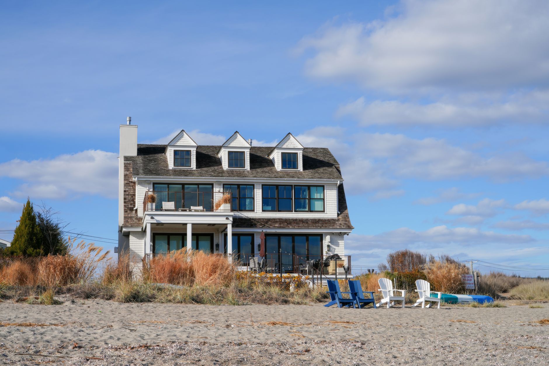 Oceanfront cottage with a deck and beach grass