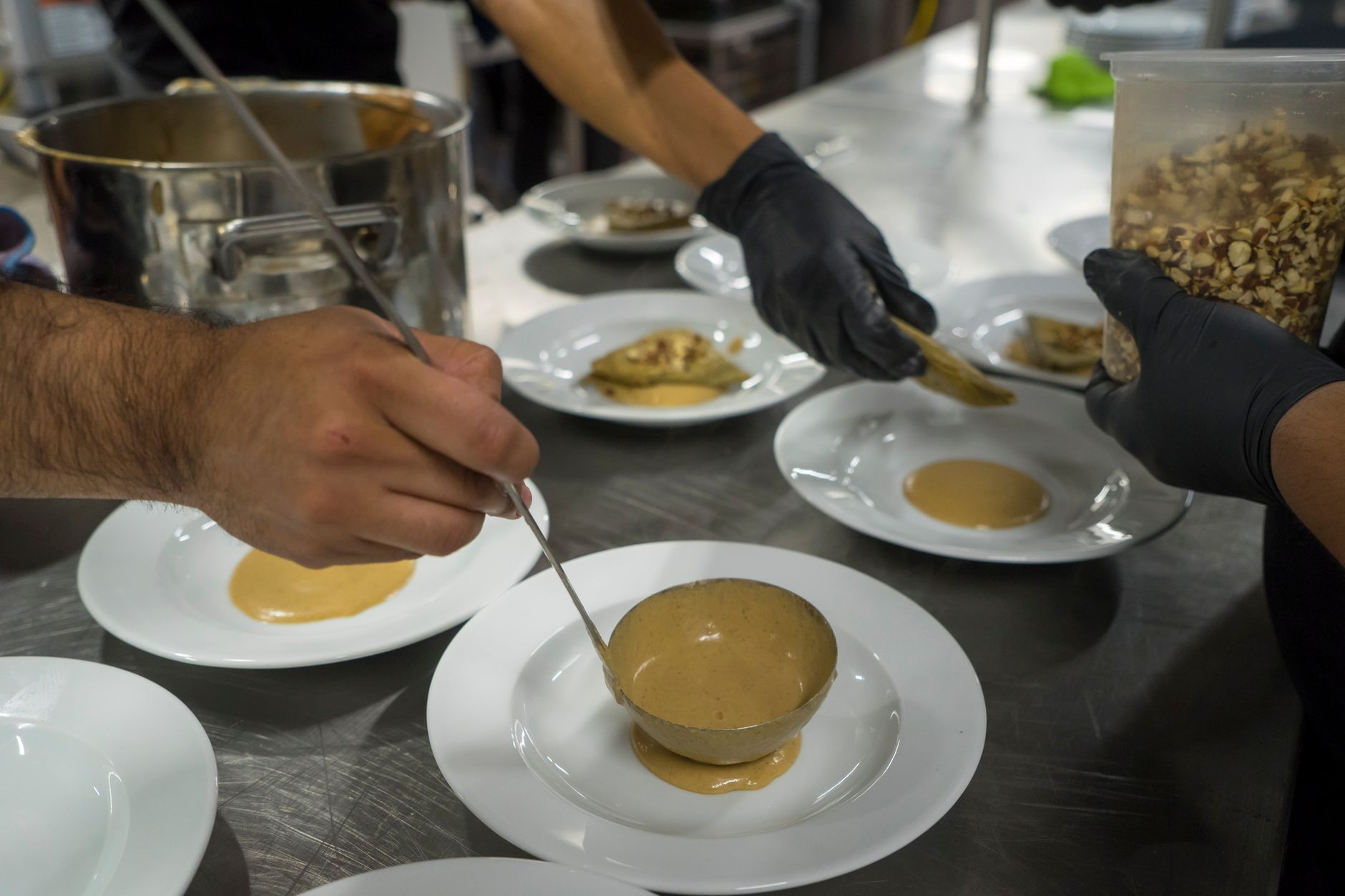 Chefs plating dishes in the kitchen