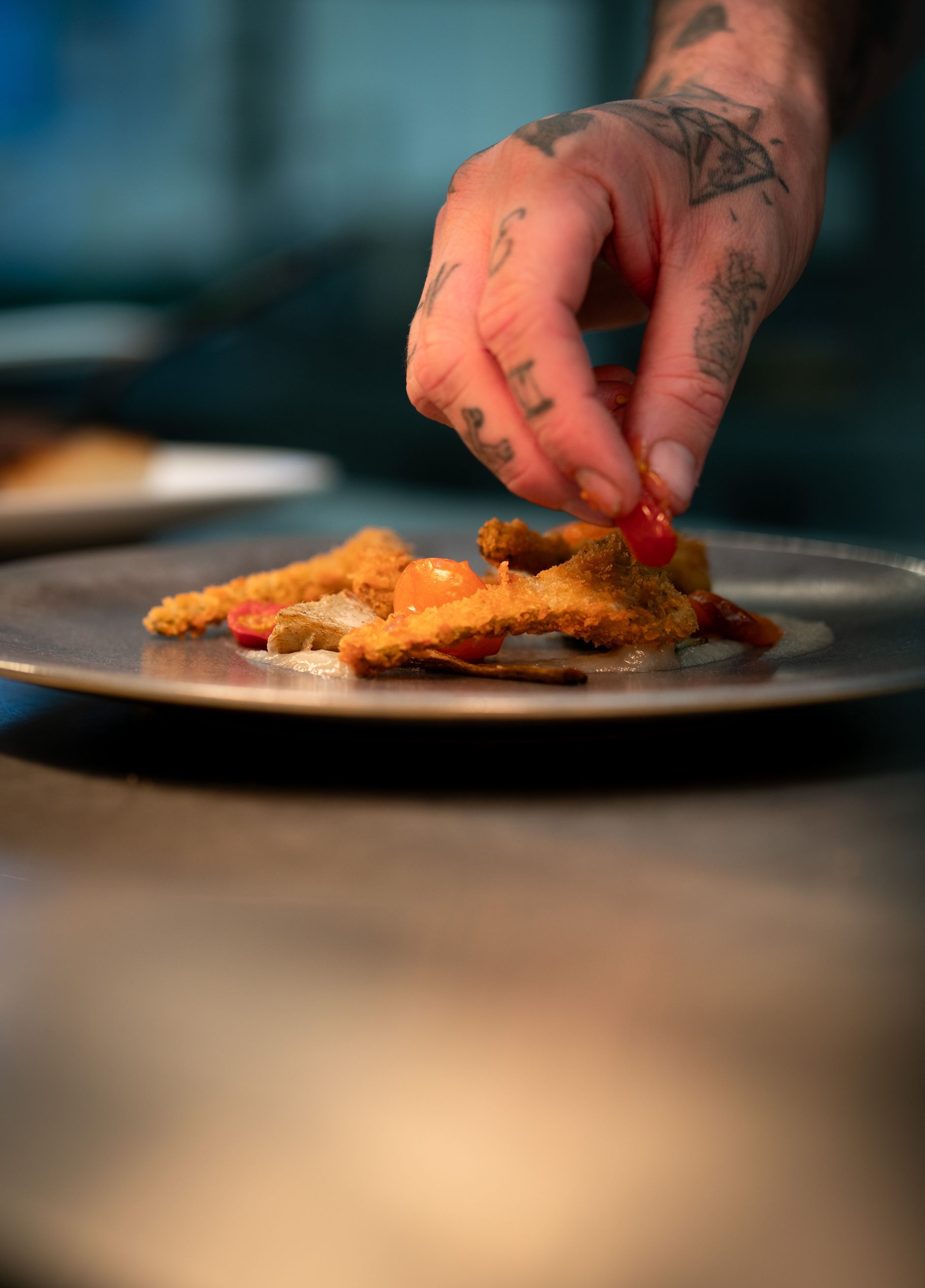 Garnishing a crispy fish dish
