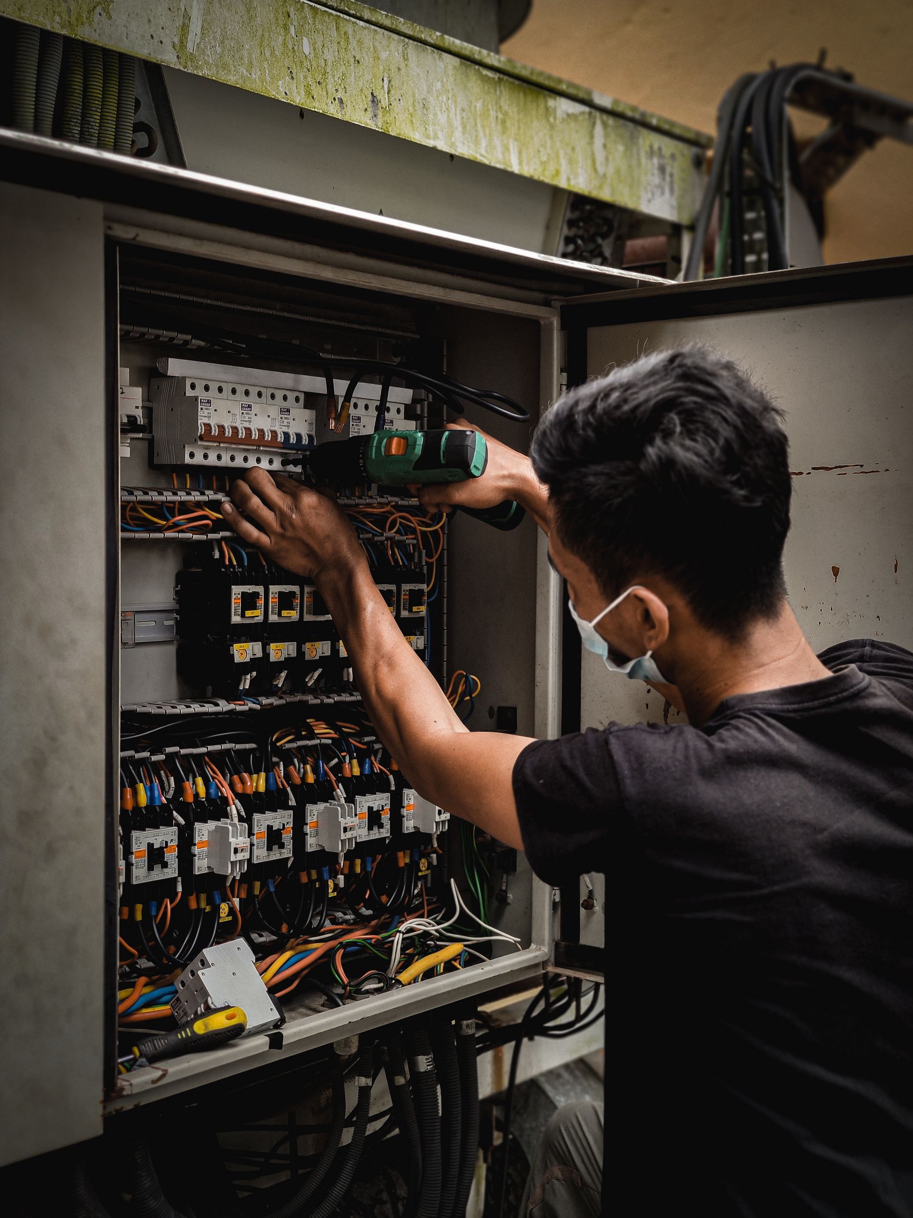 Electrician working on a breaker panel