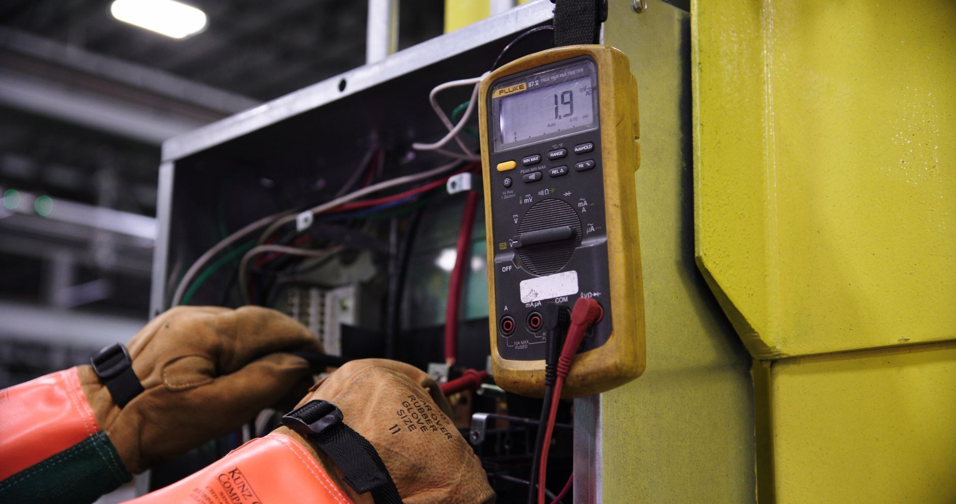 Electrician using a multimeter